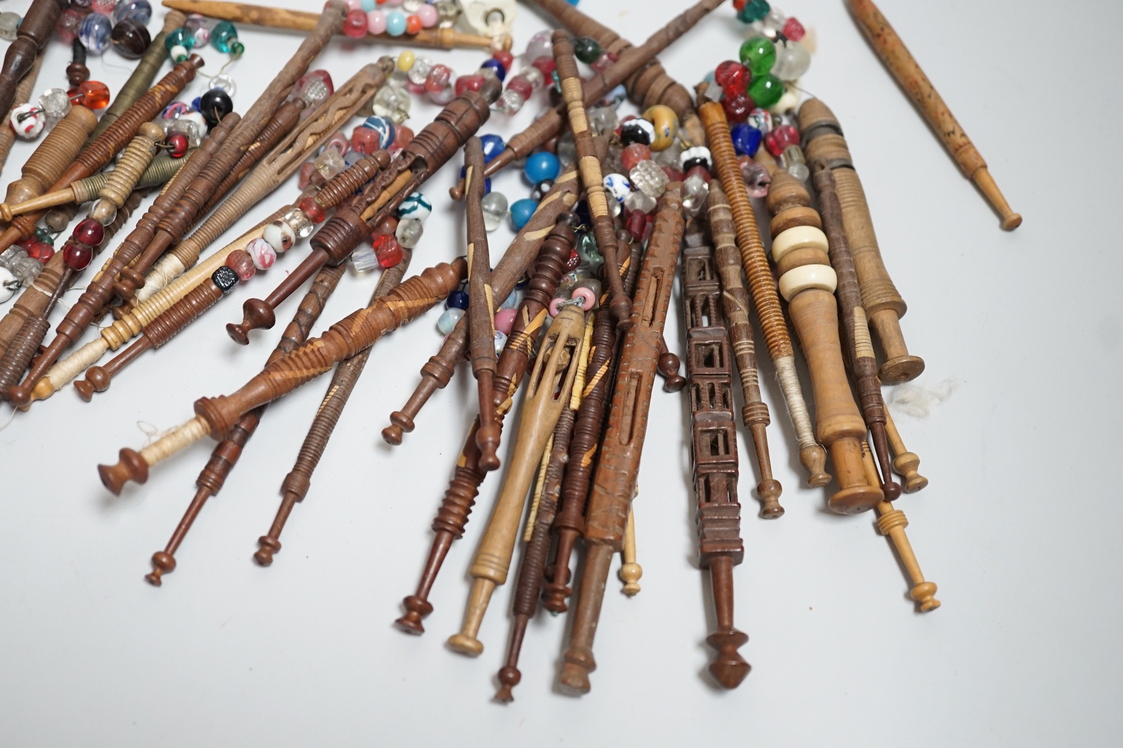 Fifty 19th century finely turned wooden lace bobbins with beaded ends together with 35 ornate wooden bobbins with beaded ends and 5 plain wooden bobbins unleaded (90)